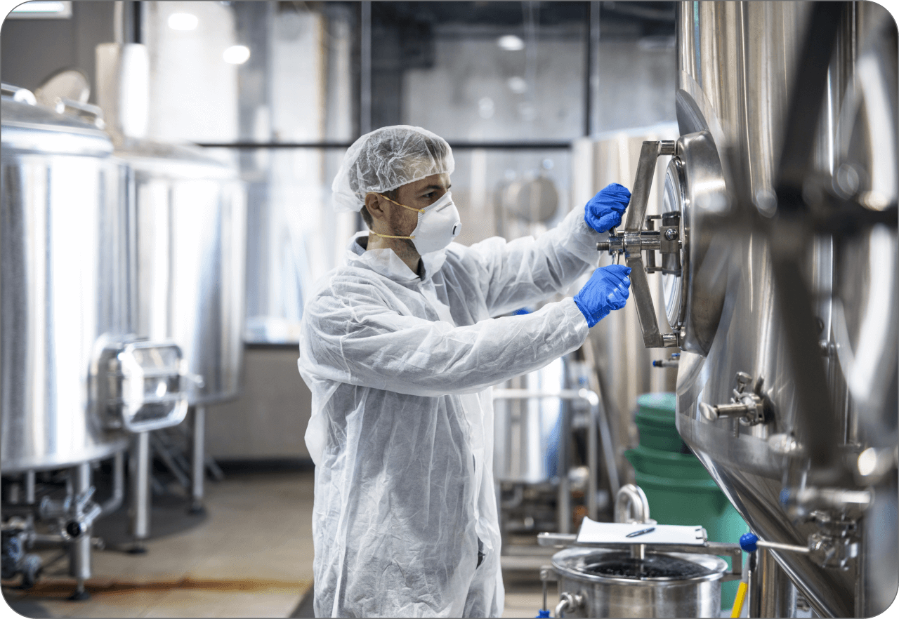 technologist-protective-uniform-wearing-hairnet-mask-goggles-gloves-closing-industrial-tank-reservoir